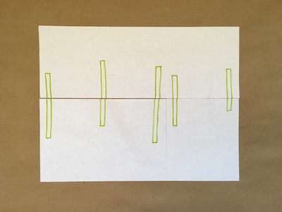 Five green rectangles on a piece of paper