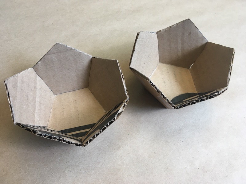Two halves of a cardboard dodecahedron