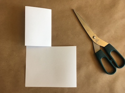 Piece of folded paper with cut down the middle