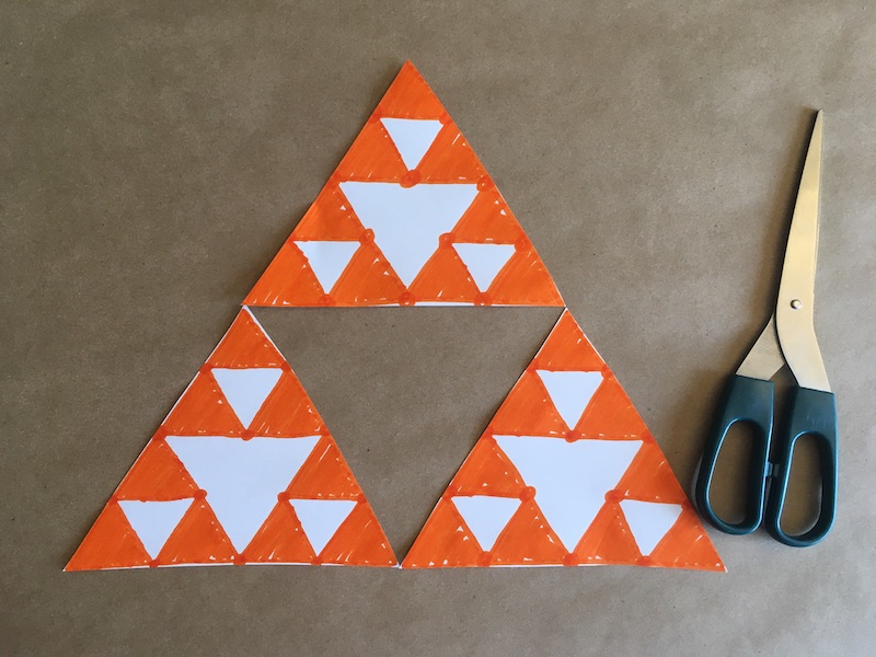 Triangles cut out making a Sierpinski Triangle