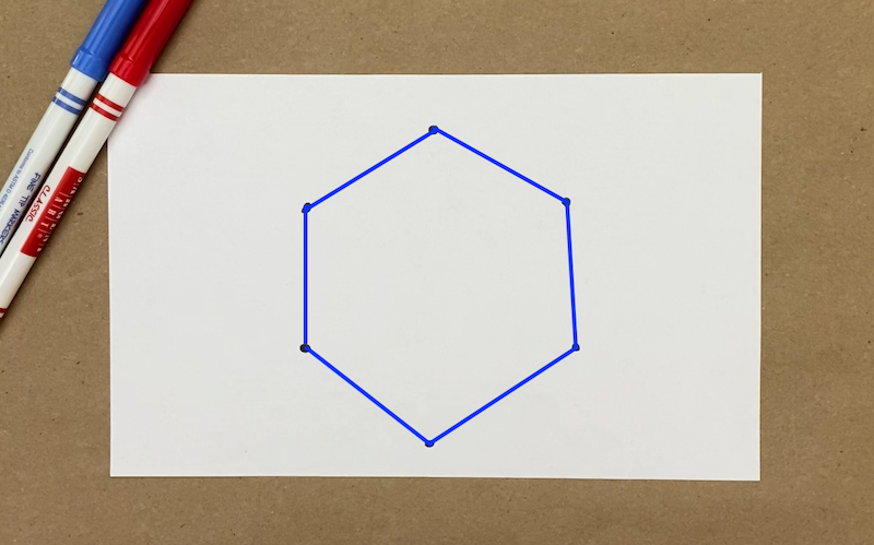 Six dots on a piece of paper with lines connecting them to make a hexagon