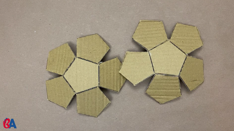 Two cardboard halves of a dodecahedron