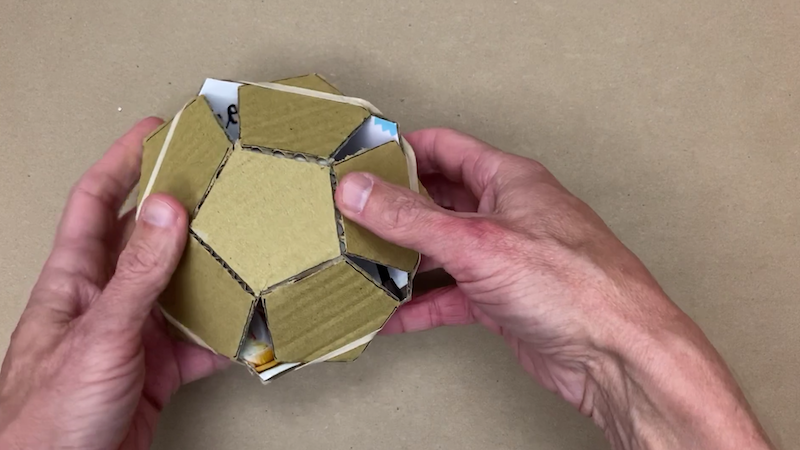 Pushing the cardboard pentagons into a dodecahedron