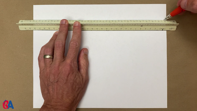 Drawing a line across a paper with a ruler