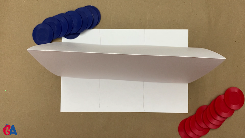 Paper divider set up between two stacks of tokens