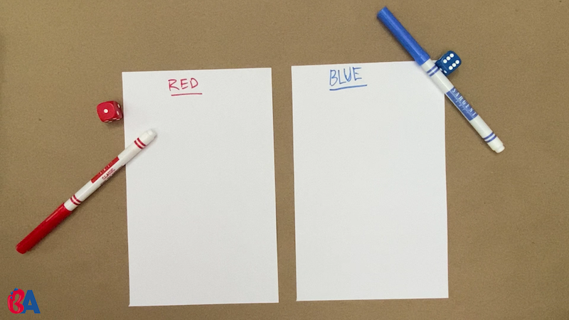 Two pieces of paper with names written at the top in red and blue