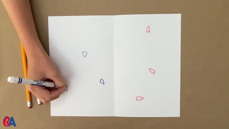 Drawing small blue and red boats on each side of a folded paper