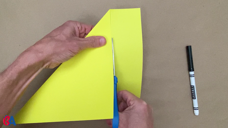 Scissors cutting off the extra strip of paper