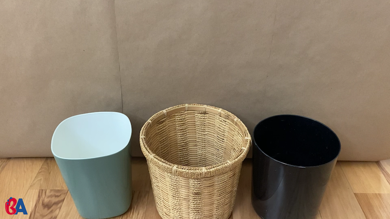 3 waste baskets lined up in a row
