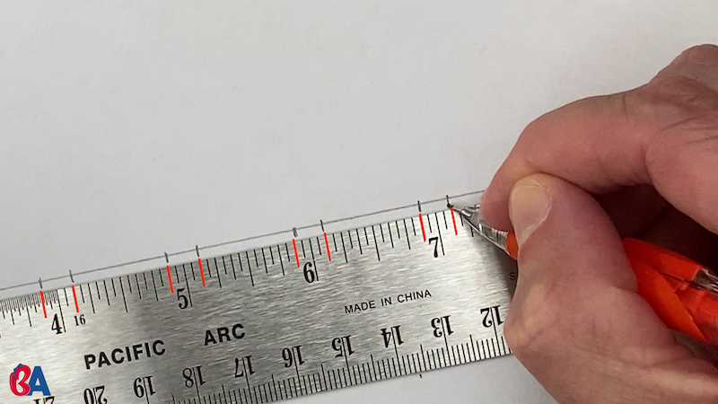 Marking along a ruler at an eighth above and below each inch mark