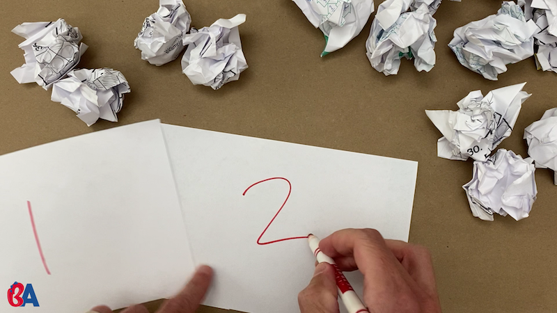 Writing numbers on pieces of paper