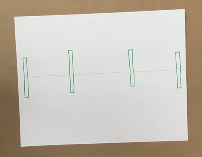 Four green rectangles drawn on a paper