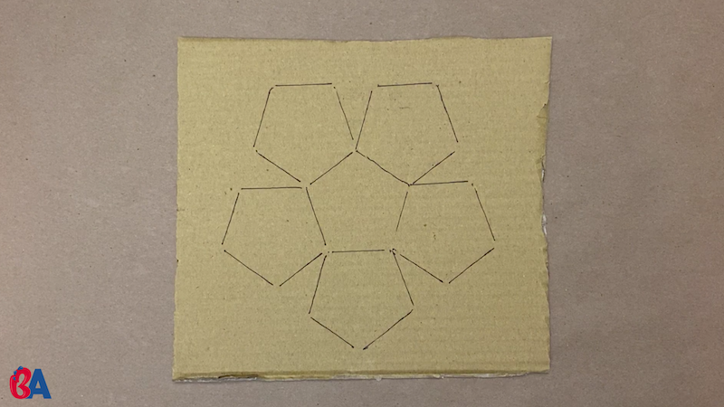 Pentagons traced onto cardboard