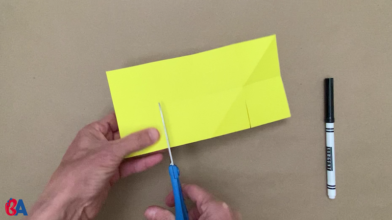 Cutting into a square of paper folded in half