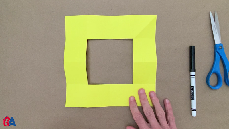 Square of paper with square hole cut out from the center
